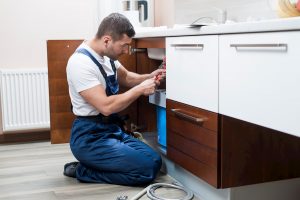 Plumbing technician fixing emergency plumbing