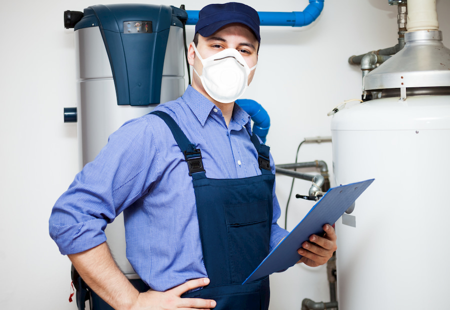 Technician preforming a water heater repair