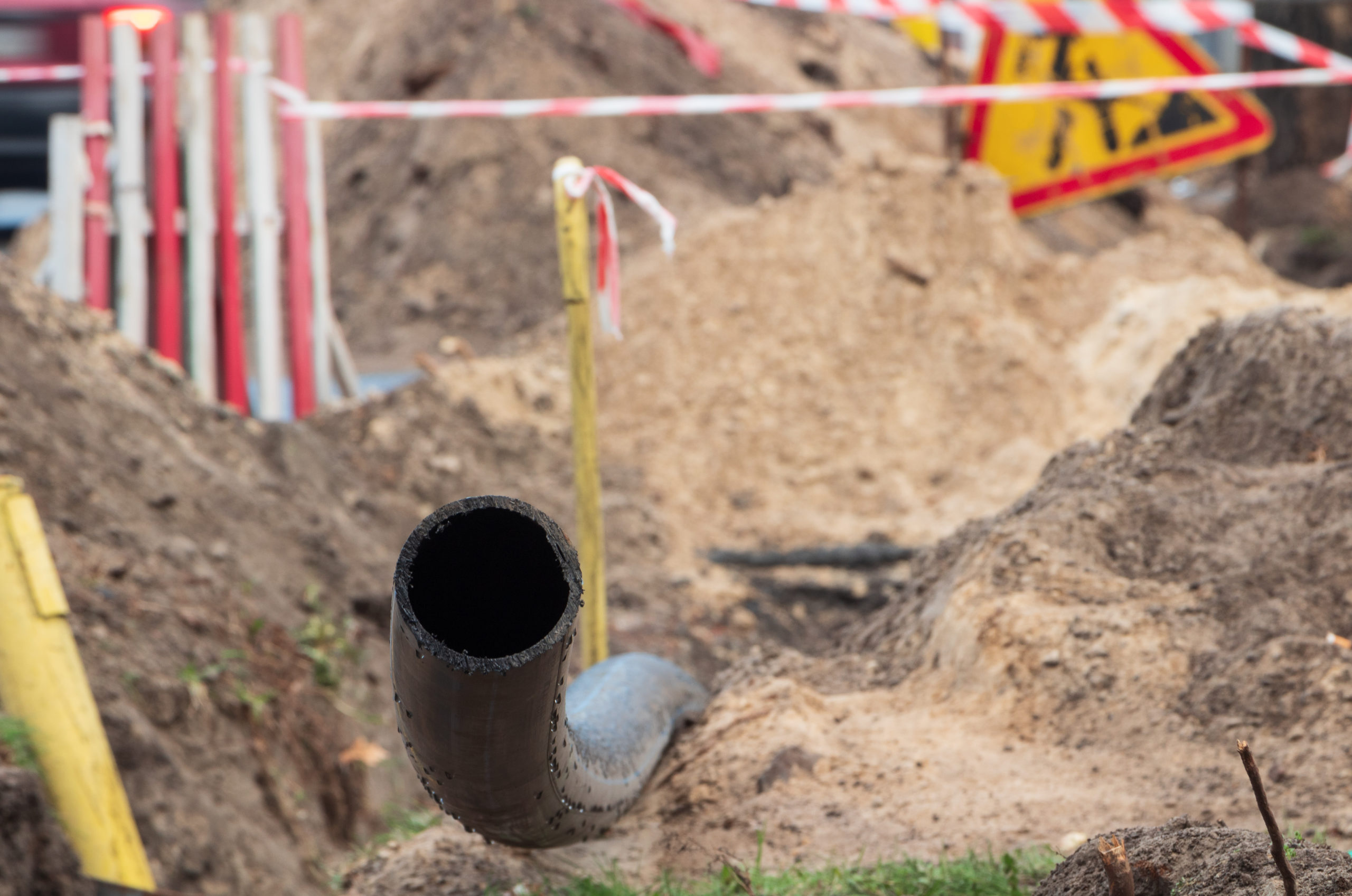 Black plastic pipe for underground water supply. pvc pipe. sewer system repair.